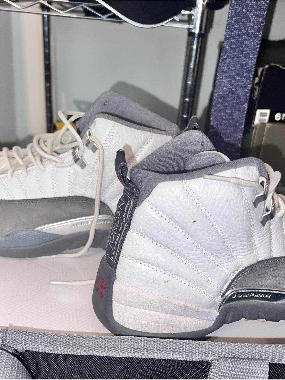 Men’s 9.5 Nike Air Jordan 12 Retro sneakers in a white and dark grey colorway